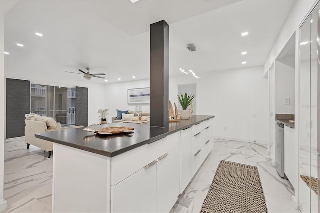 kitchen featuring pendant lighting, dishwasher, white cabinets, ceiling fan, and a kitchen island