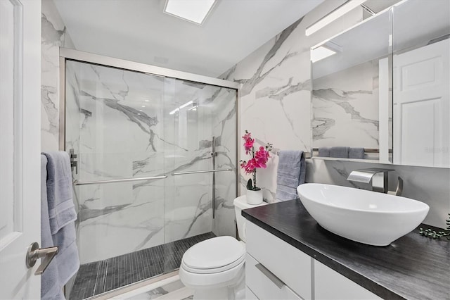 bathroom with vanity, an enclosed shower, and toilet