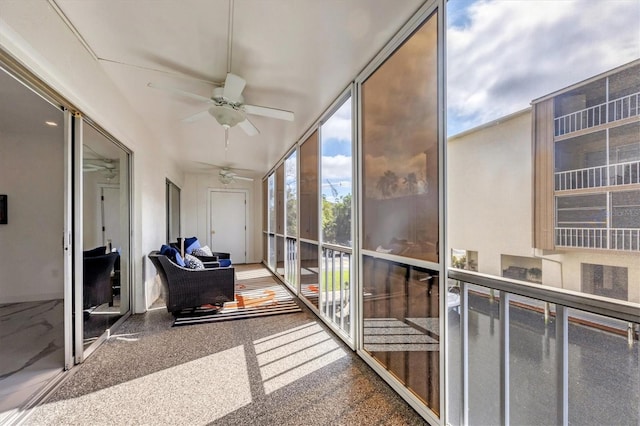 sunroom featuring ceiling fan