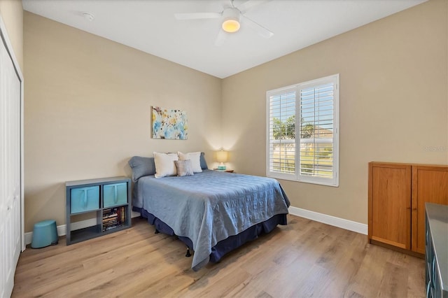 bedroom with ceiling fan, a closet, and light wood-type flooring