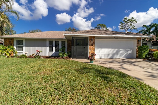 ranch-style house featuring a front lawn and a garage