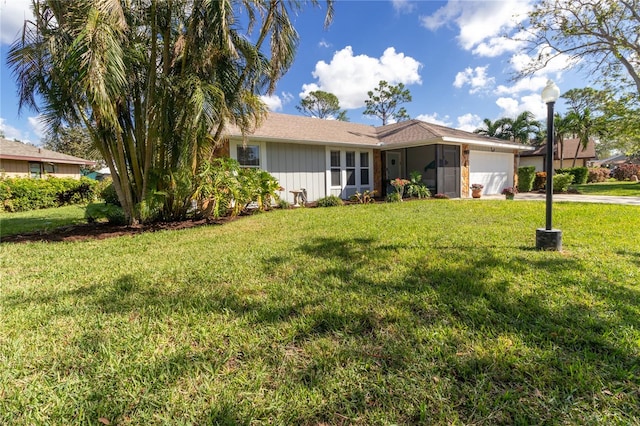 ranch-style home with a front yard and a garage