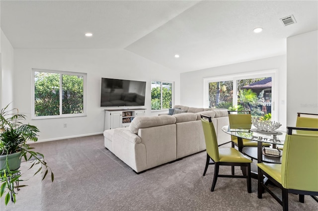 living room with carpet, a healthy amount of sunlight, and lofted ceiling