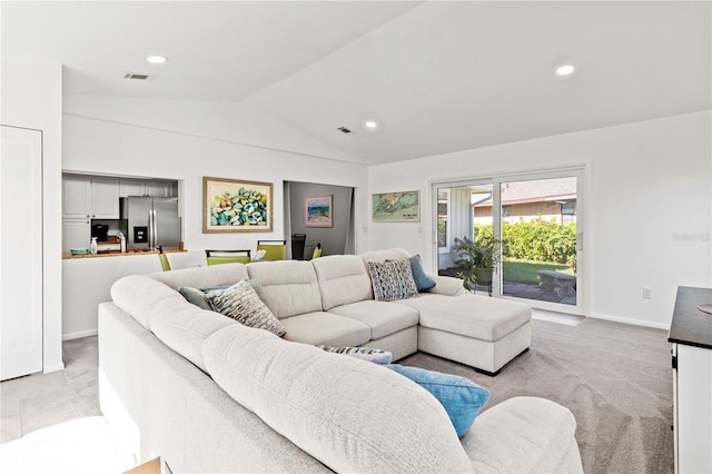 carpeted living room with lofted ceiling