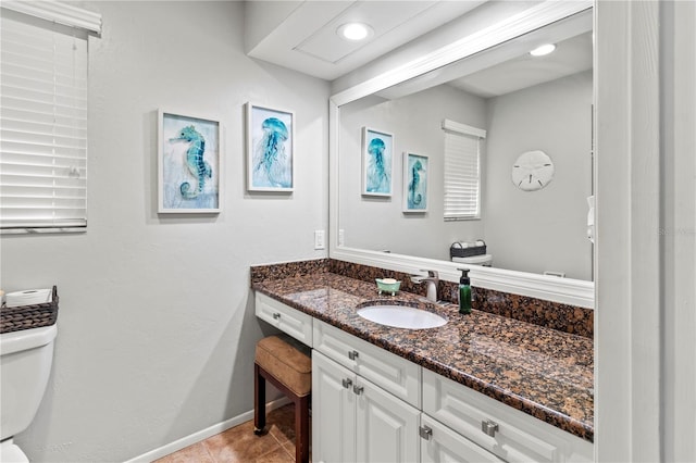 bathroom with tile patterned floors, vanity, and toilet