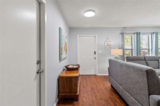 interior space featuring a textured ceiling and dark wood-type flooring