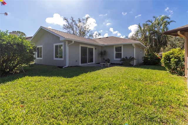 back of house with a lawn