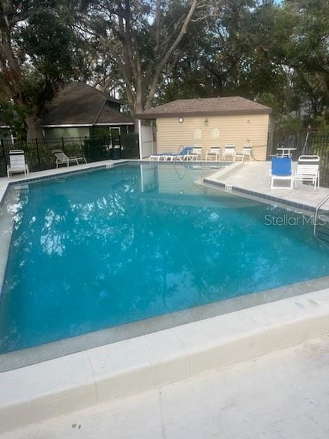 view of pool with an outdoor structure