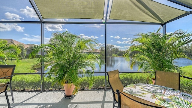 unfurnished sunroom featuring a water view