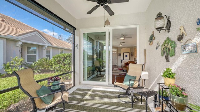 sunroom / solarium featuring ceiling fan