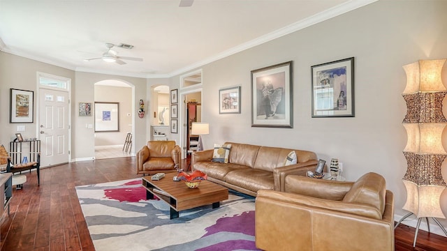 living room with dark hardwood / wood-style flooring, ornamental molding, and ceiling fan