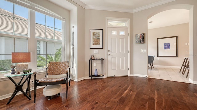 foyer entrance featuring hardwood / wood-style floors and ornamental molding