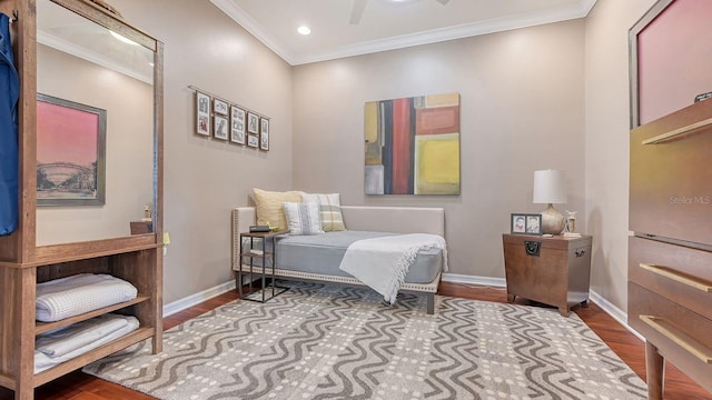 bedroom with crown molding, ceiling fan, and dark hardwood / wood-style floors