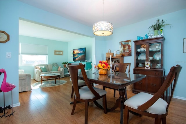 dining space with wood-type flooring