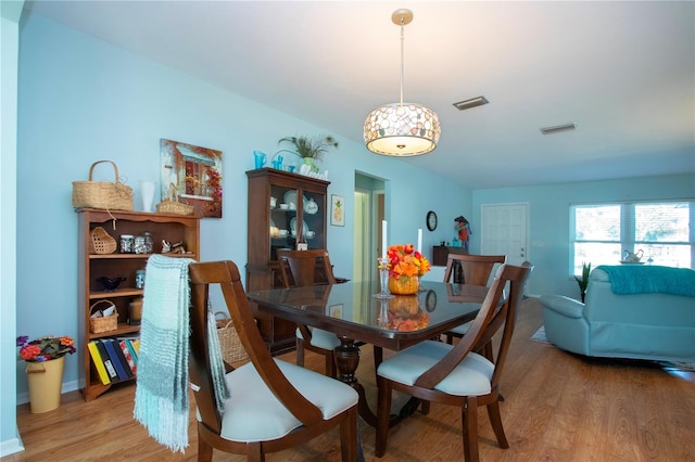 dining space with hardwood / wood-style flooring