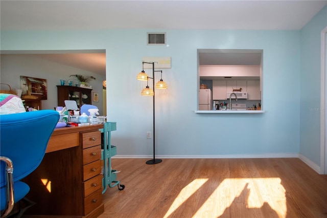 office area with sink and wood-type flooring