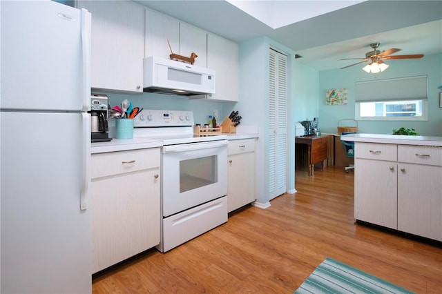 kitchen with white appliances, white cabinetry, light hardwood / wood-style flooring, and ceiling fan