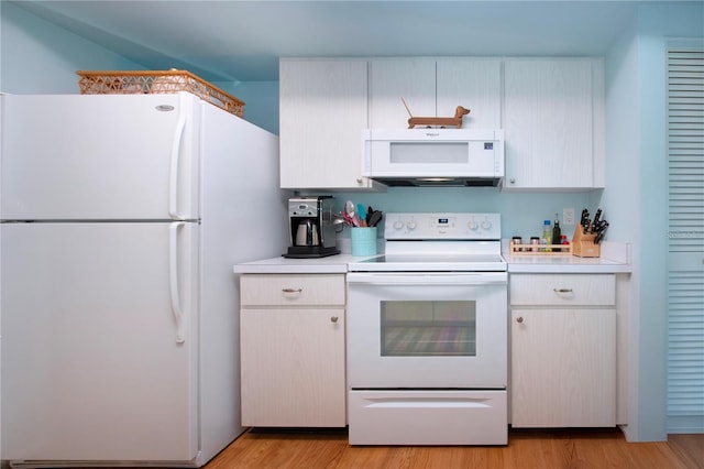 kitchen with white appliances, white cabinetry, and light hardwood / wood-style flooring