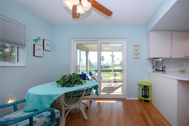 dining space with light wood-type flooring and ceiling fan