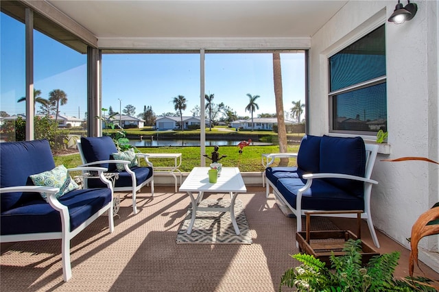 sunroom / solarium with a water view