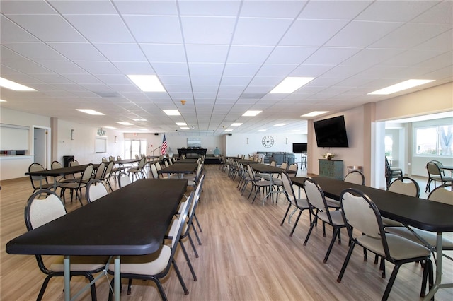 dining space featuring light hardwood / wood-style floors and a drop ceiling