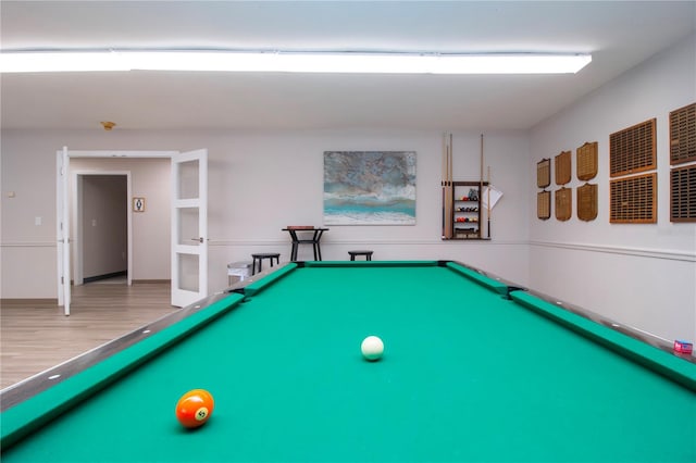 recreation room with hardwood / wood-style floors and billiards