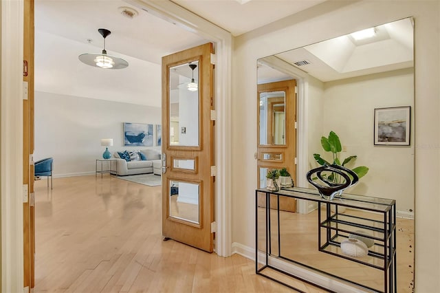 corridor with light hardwood / wood-style floors