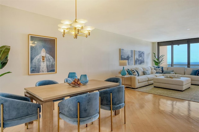 415 L Ambiance Dr Unit C703, Longboat Key, FL 34228 - dining space featuring a chandelier and light wood finished floors