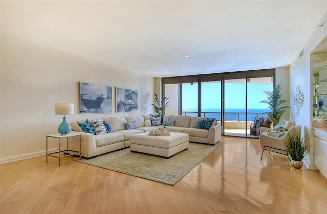 415 L Ambiance Dr Unit C703, Longboat Key, FL 34228 - living area with hardwood / wood-style flooring, floor to ceiling windows, and baseboards