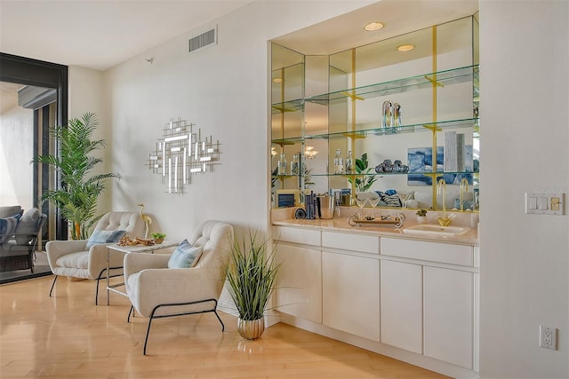 415 L Ambiance Dr Unit C703, Longboat Key, FL 34228 - bar area with a sink and light wood-style flooring