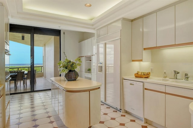 kitchen with sink, white dishwasher, and a kitchen island