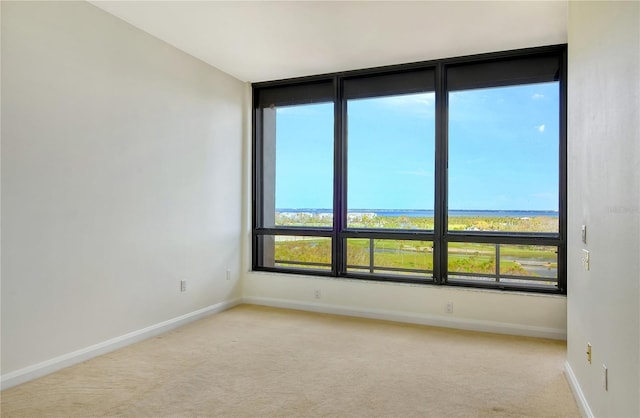 415 L Ambiance Dr Unit C703, Longboat Key, FL 34228 - unfurnished room with light carpet, baseboards, and plenty of natural light