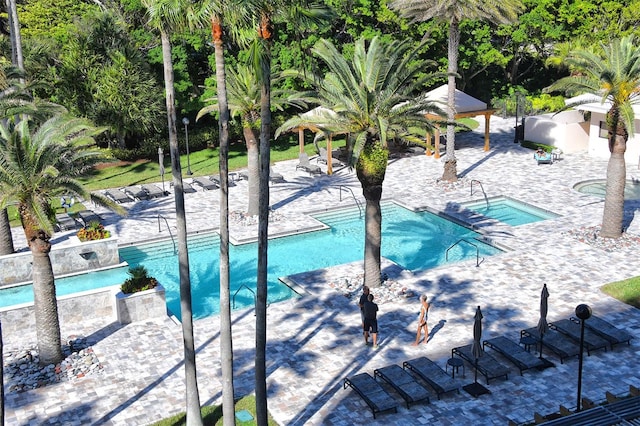 view of pool featuring a hot tub, a patio, and a gazebo