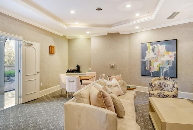 carpeted home theater featuring ornamental molding and a tray ceiling