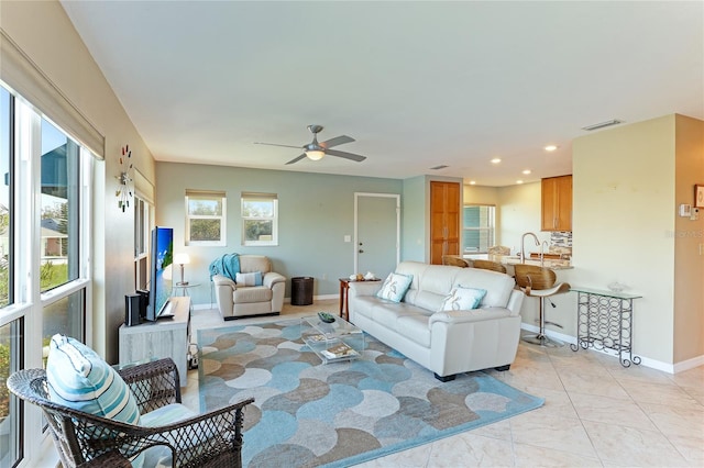 living room with light tile patterned floors and ceiling fan