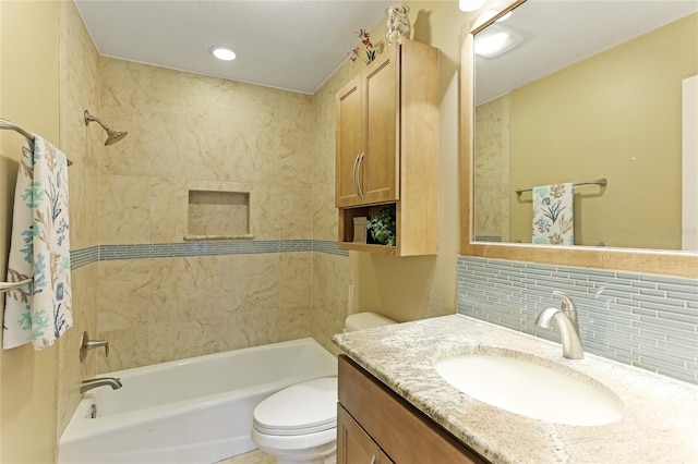 full bathroom with toilet, tasteful backsplash, tiled shower / bath combo, and vanity