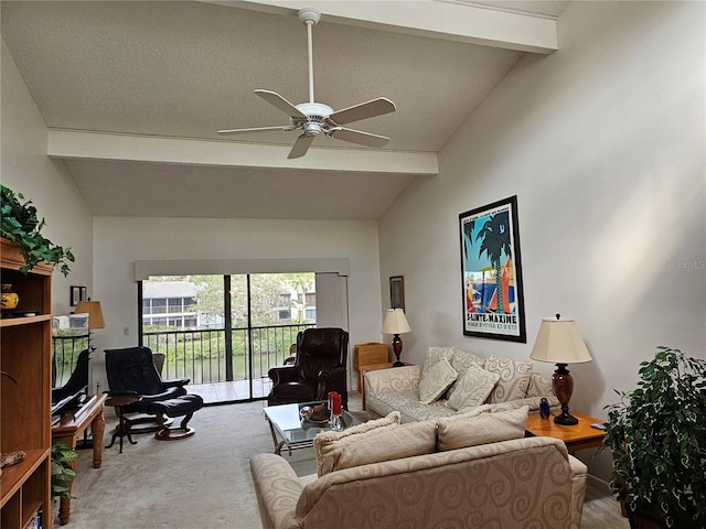 living room with beamed ceiling, a textured ceiling, carpet floors, and ceiling fan