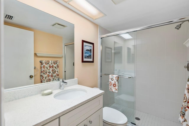 bathroom with vanity, toilet, and walk in shower