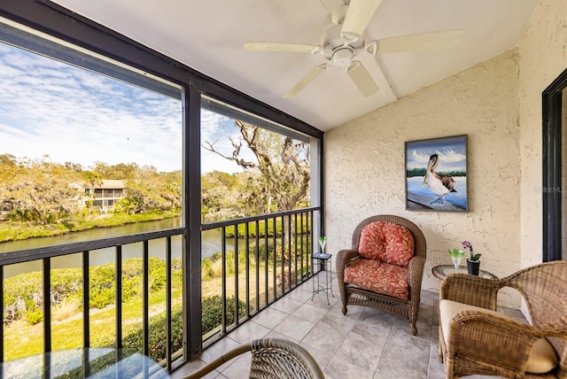 balcony with ceiling fan and a water view