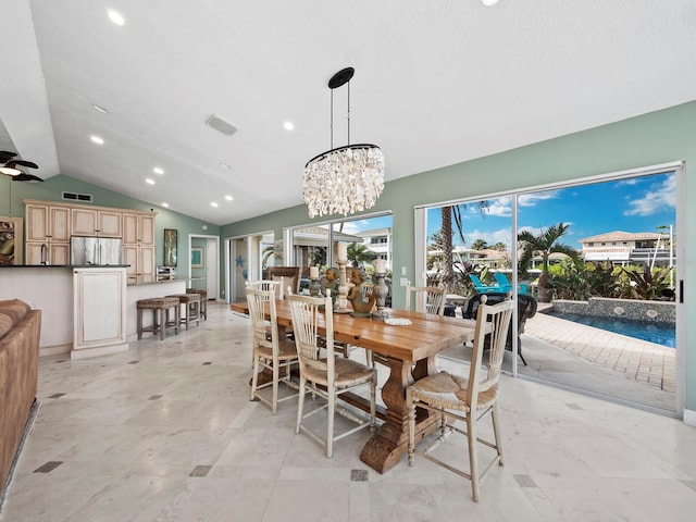 dining area featuring a chandelier and lofted ceiling