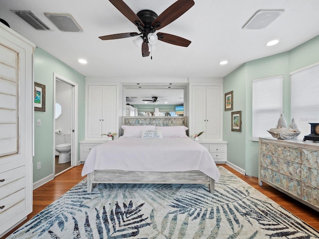 bedroom with ensuite bath, ceiling fan, and hardwood / wood-style floors