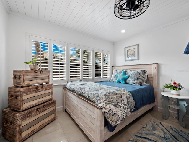 bedroom with light tile patterned floors and wooden ceiling