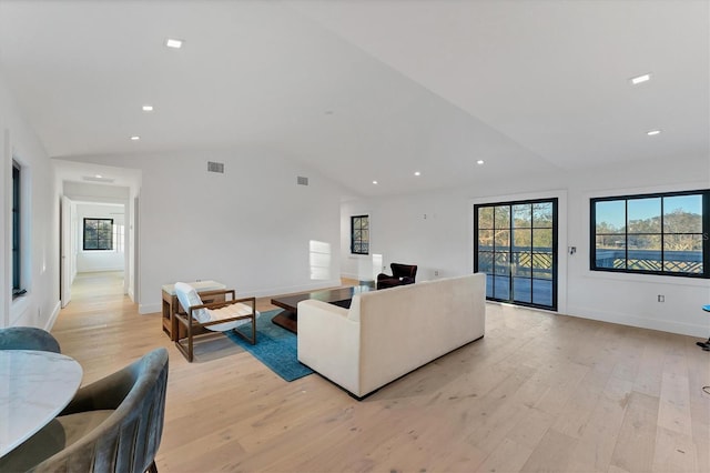 living room with vaulted ceiling and light hardwood / wood-style floors