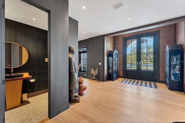 entrance foyer featuring french doors and light hardwood / wood-style flooring