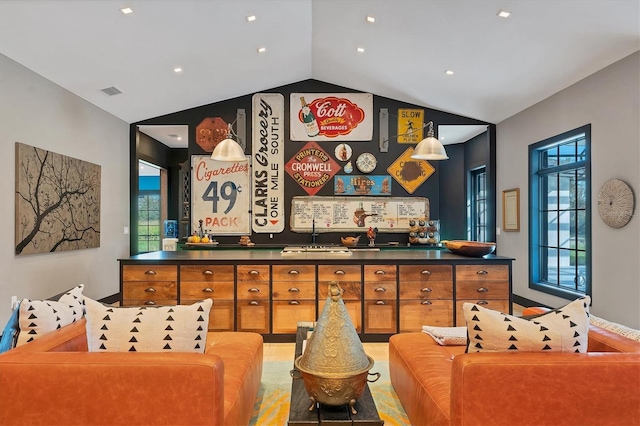 sitting room with lofted ceiling