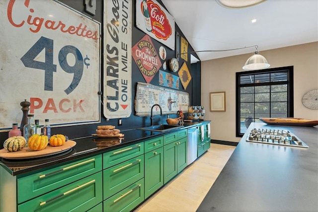 kitchen featuring sink, green cabinets, light wood-type flooring, and appliances with stainless steel finishes