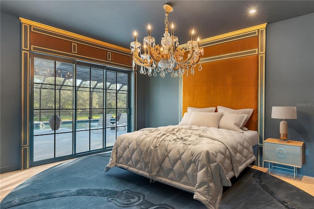 bedroom featuring access to exterior and a chandelier