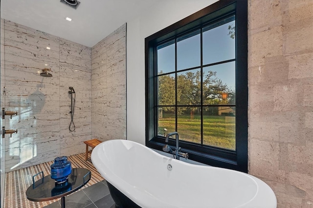 bathroom featuring independent shower and bath