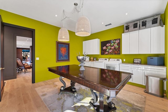 game room with washer and dryer and light wood-type flooring