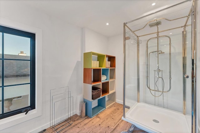 bathroom with hardwood / wood-style flooring and walk in shower